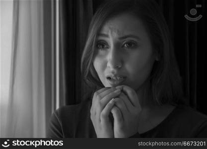 Young woman looking extremely stressed