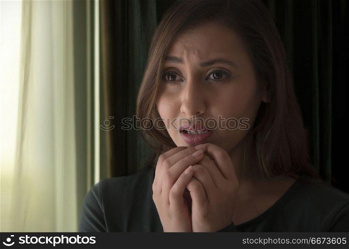 Young woman looking extremely stressed