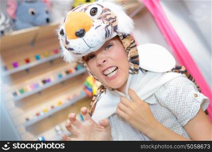 young woman looking for costume in rental store