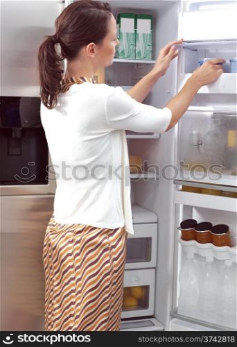 Young woman looking for something to eat