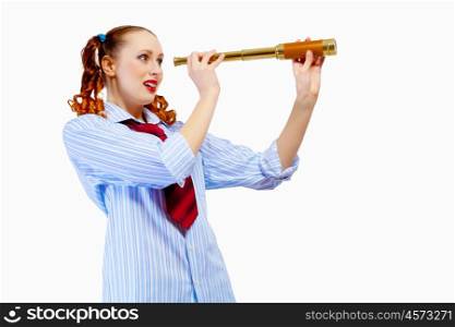 Young woman looking in telescope. Young pretty woman in red glasses looking in telescope