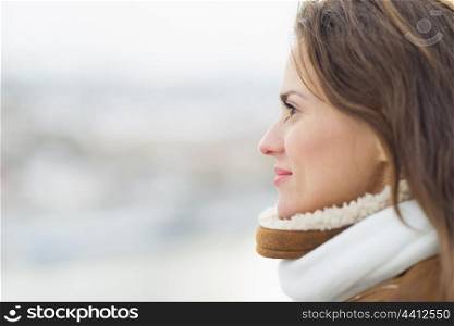 Young woman looking into distance in winter outdoors.