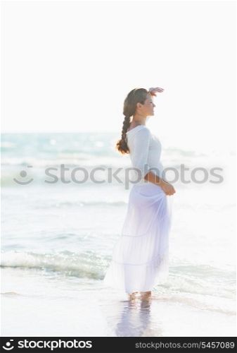 Young woman looking into distance on sea shore