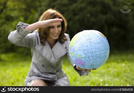 Young Woman Looking On Globe. Travel Concept.