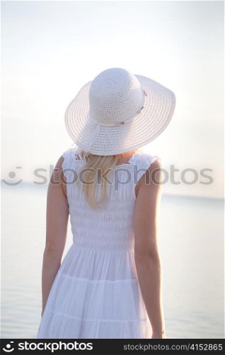 Young woman looking on the sunrise. Travel collection.
