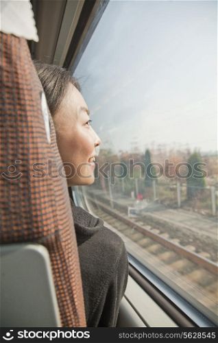 Young Woman Looking Out the Window of a Train
