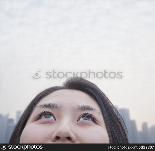 Young woman looking up