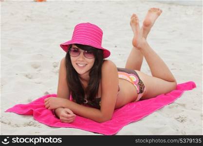 young woman lying down on the beach