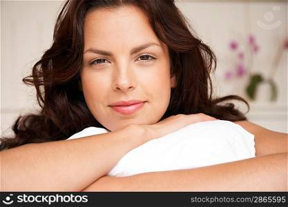 Young woman lying in bed head and shoulders