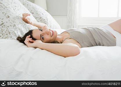 Young woman lying on bed