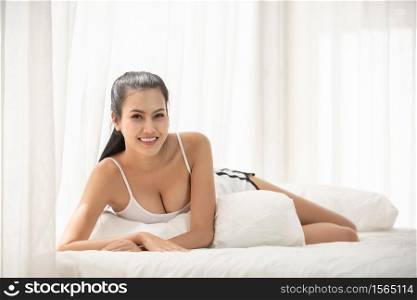 Young Woman Lying On Bed At Home