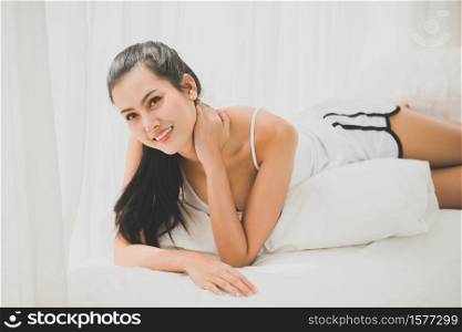 Young Woman Lying On Bed At Home .