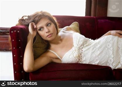 Young woman lying on couch