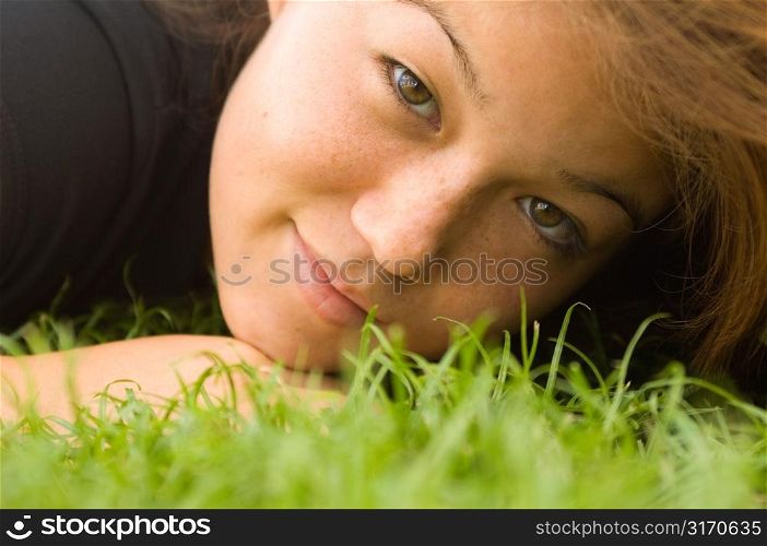 Young Woman Lying on Grass