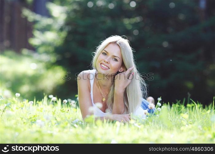 young woman lying on grass. young blond woman lying on grass