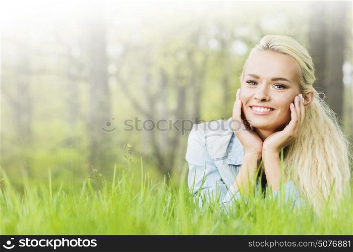 Young woman lying on grass. Young woman lying on the grass in spring park