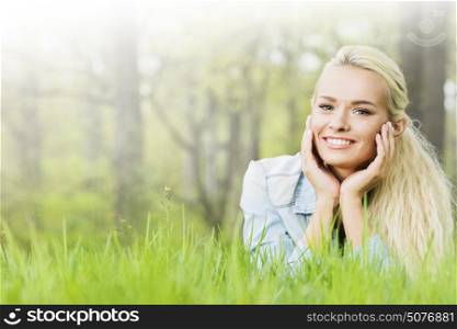 Young woman lying on grass. Young woman lying on the grass in spring park