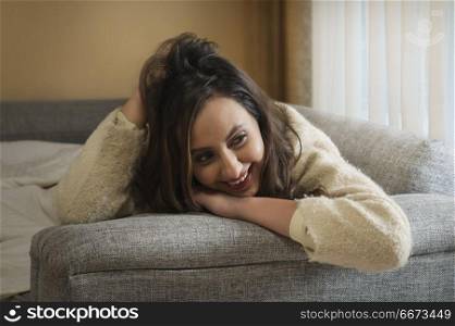Young woman lying on sofa
