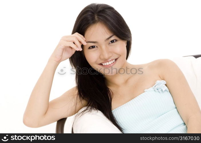 Young woman lying on the bed and reading a book