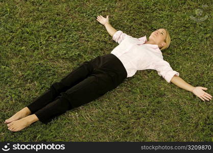 Young woman lying on the grass