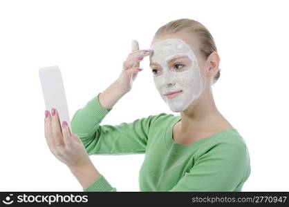 young woman making a spa mask on your face. Isolated on white background