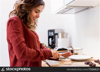 Young woman making chocolate peanut cookies