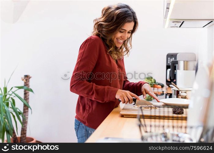 Young woman making chocolate peanut cookies