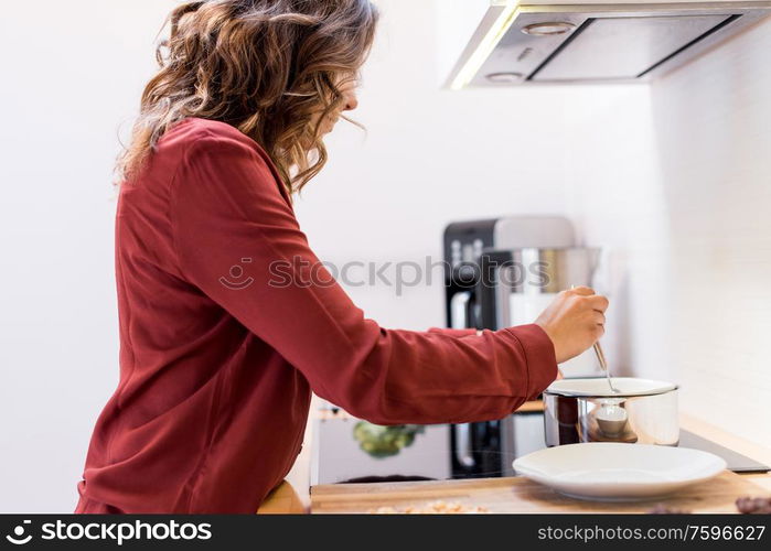 Young woman making chocolate peanut cookies