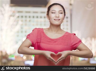 Young Woman Making Heart Sign with Hands
