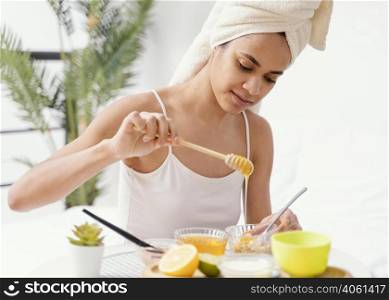 young woman making natural face mask home 2
