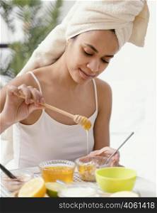 young woman making natural face mask home