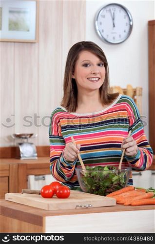 young woman making salad