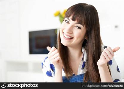 Young Woman Making Thumbs Up Gesture With Hands