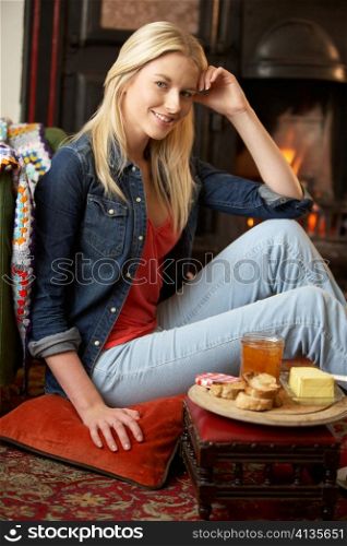 Young woman making toast on open fire