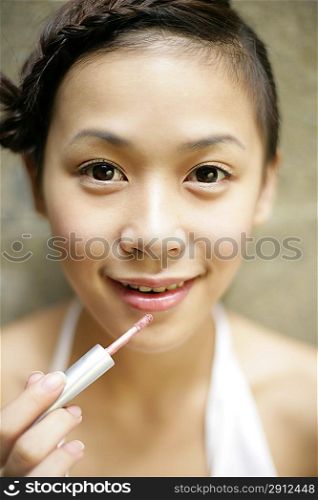Young woman making up