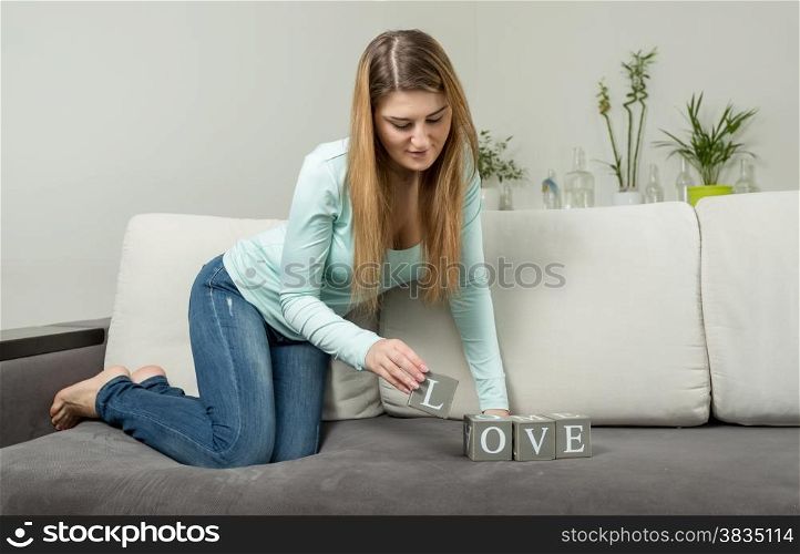 Young woman making word