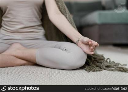 young woman meditating home close up