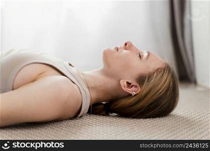 young woman meditating home laid floor
