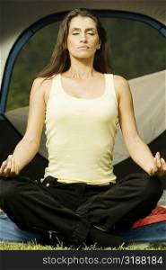 Young woman meditating with her eyes closed