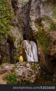 Young woman near a waterfall