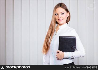 Young woman office worker hold case with files.. Career business work in office. Young woman in formal wear hold case with files documents paperwork.