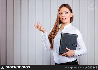Young woman office worker hold case with files.. Career business work in office. Young woman in formal wear hold case with files documents paperwork presenting gesture.