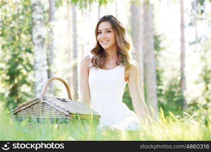 young woman on a picnic. young woman in yellow dress on a picnic