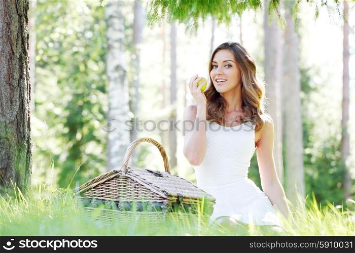 young woman on a picnic. young woman in yellow dress on a picnic