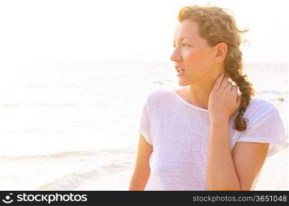 young woman on beach at sunrise