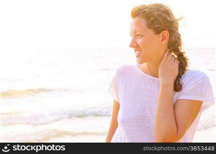 young woman on beach at sunrise
