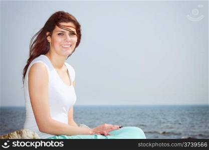 young woman on beach enjoying summer holiday