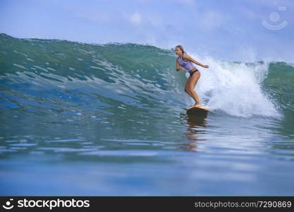 Young woman on blue wave