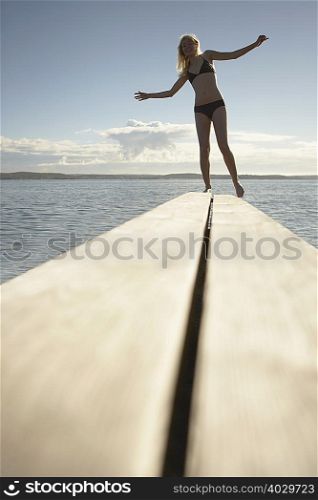 Young woman on diving board