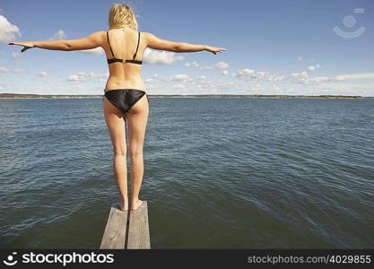 Young woman on diving platform